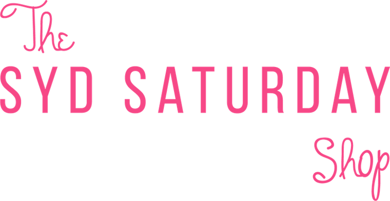 Pink text reading 'The SYD SATURDAY Shop' on a solid black background.